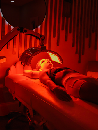 Gentle red glow from POLY Red Light Therapy at Body Lab Studio in Myrtle Beach.